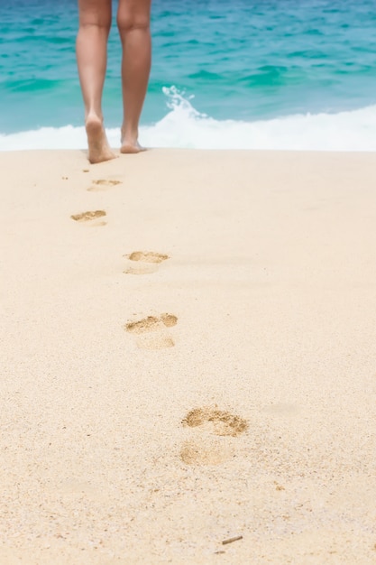 Human footprints on the white sandy beach