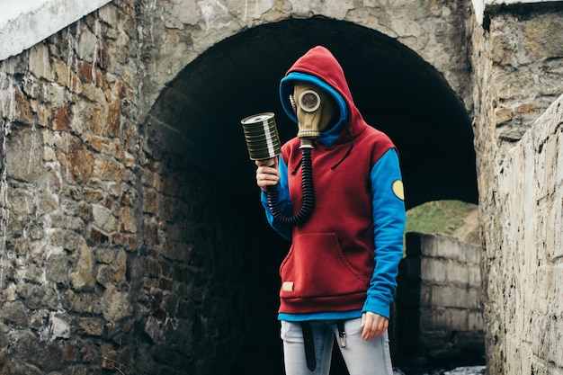 Human in gas mask in old stone tunnel