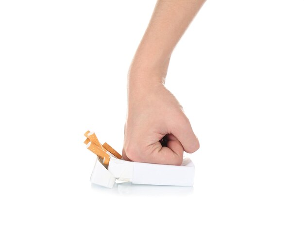 human hand crushing cigarettes on white background