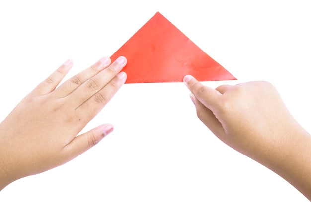 Human hand folding a colored paper isolated over white background