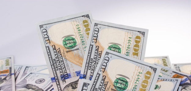 Human hand holding American dollar banknotes on white background