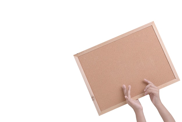 Human hand holding a brown cork board in a frame isolated over white wall