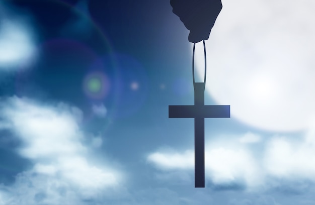 Human hand holding Christian cross with the night scene background