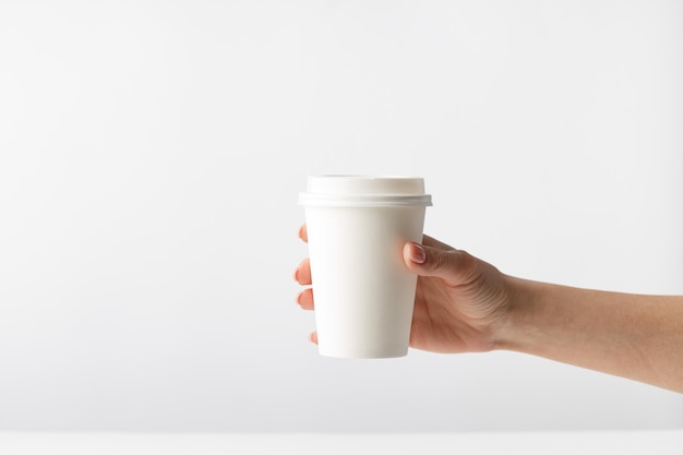 Human hand holding a coffee cup