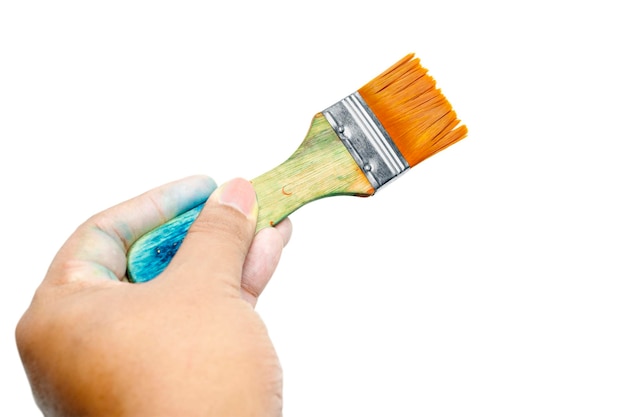 Photo human hand holding dirty paintbrushes