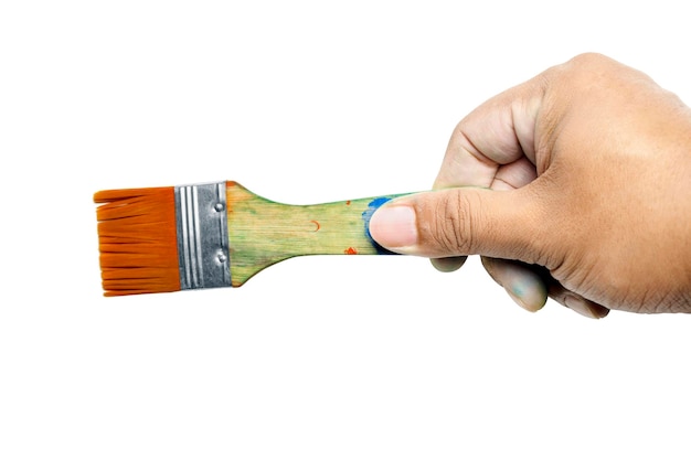 Human hand holding dirty paintbrushes