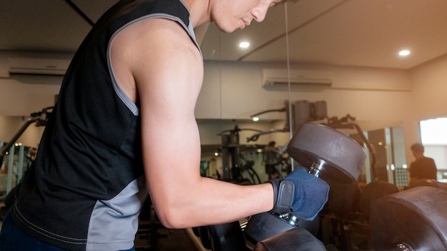 Human Hand holding dumbbell in gym