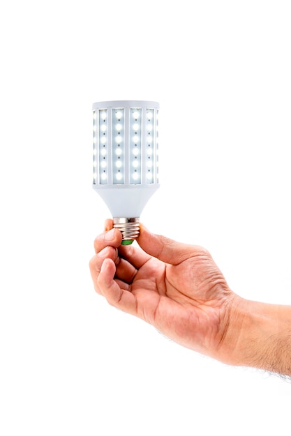 Photo human hand holding led light bulb isolated on white background.