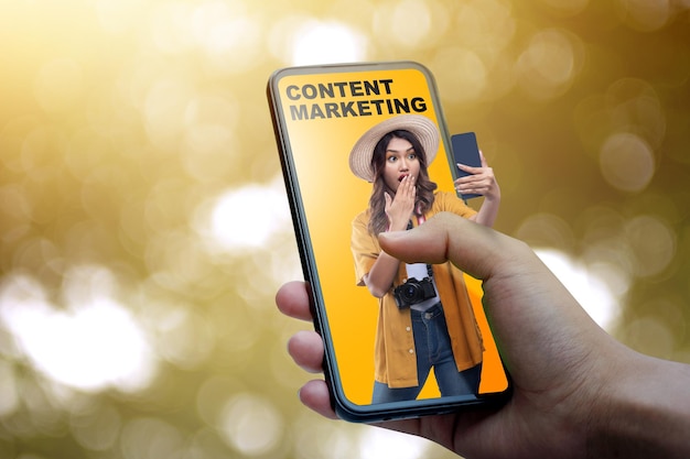 Human hand holding mobile phone with a view of traveler woman and content marketing text