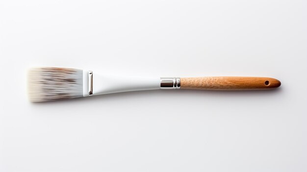 human hand holding a paintbrush