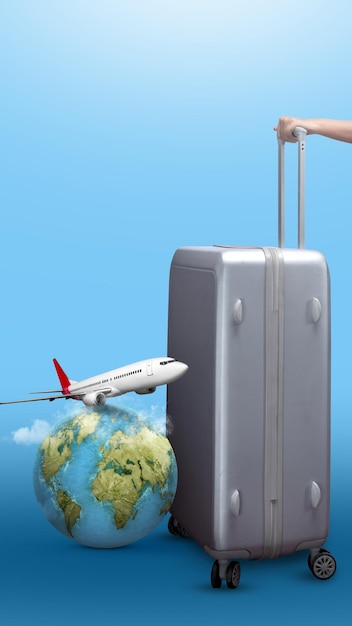 a human hand holding a suitcase with a globe and a flying airplane on a colored background ready for traveling