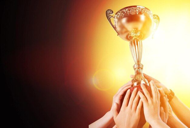 The human hand holds the champion golden trophy Success concept