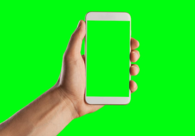 Human hand shows mobile smartphone with green screen