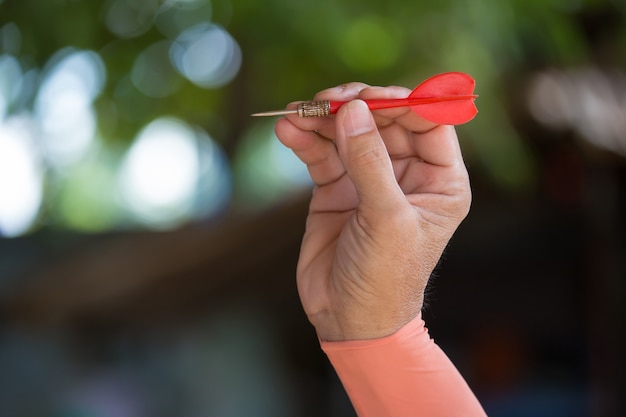 human hand with dart closeup