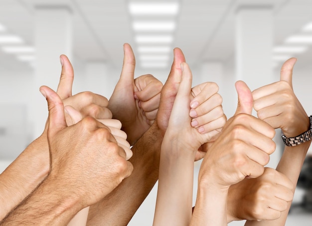 Human hands gesturing thumbs up, close up