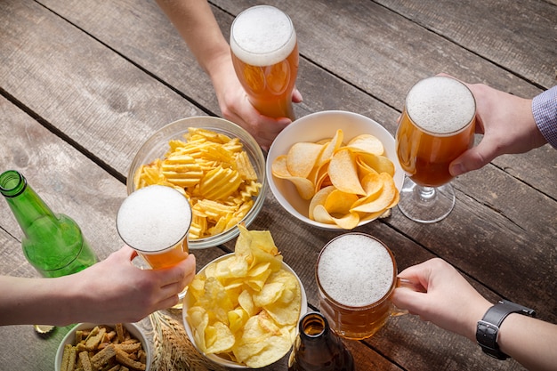 Human hands and glasses of beer 