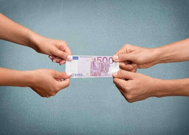 Human hands holding euro banknote on background