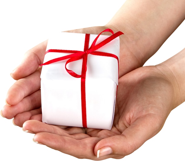 Human hands holding Little christmas box with bow isolated on white background