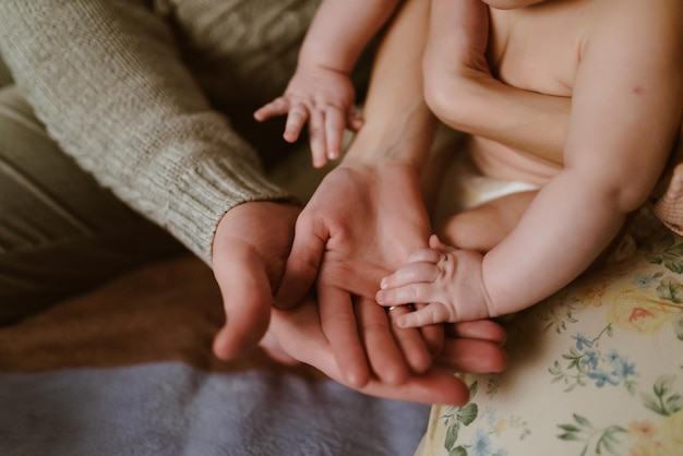 Human hands of mom and baby dad