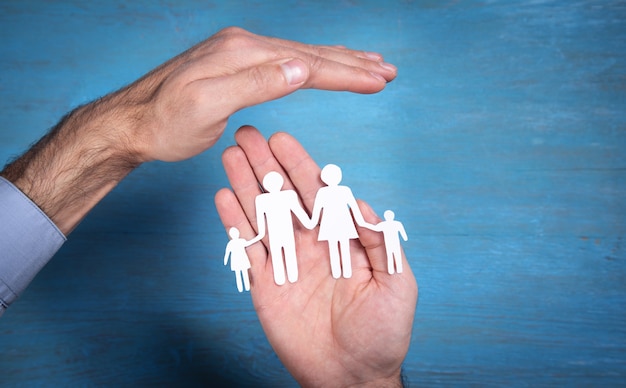 Human hands showing paper cut family.