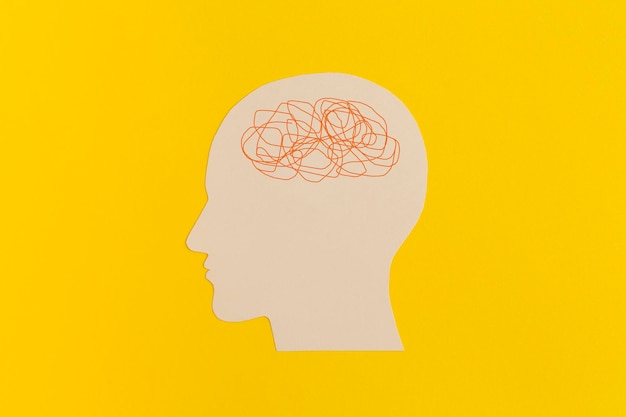 Human head with confused thoughts on yellow background