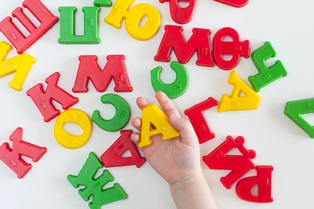 Photo on human health a phrase for health made up of multicolored plastic letters the wish of health good wish wishing health to another yellow green red blue bright inscription made up by a child