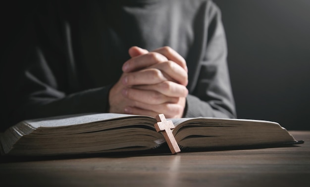 Human praying with Bible. Religion