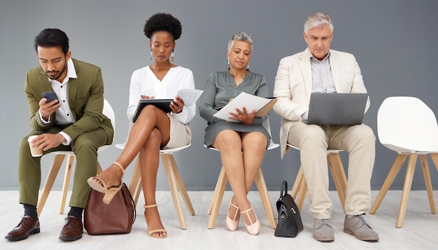 Photo human resources technology and business people waiting in line for an interview during recruitment hiring resume or cv with a man and woman employee sitting in an hr candidate line for opportunity