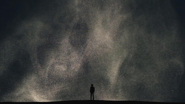 Premium Photo | The human silhouette standing on a dark cloudy background