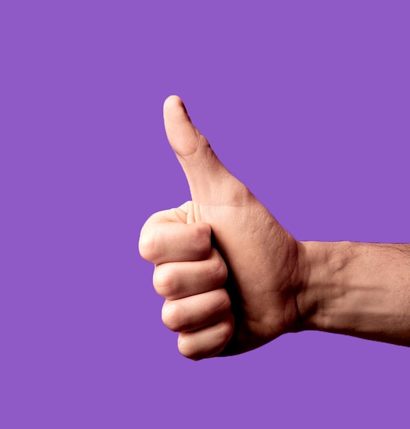 human thumb up on purple background