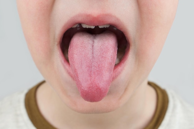 Human tongue protruding out Child tongue