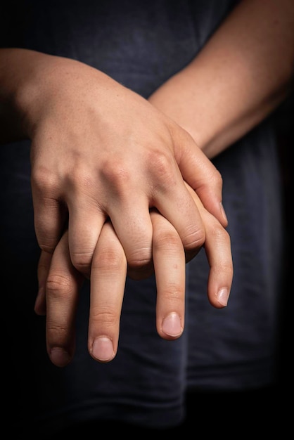 Human with fingers interlocked close up