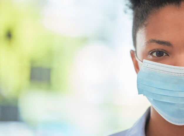 Humanity care and protection person in covid mask with half face pose on bokeh or blurred healthcare background Hygiene woman covering face to stop the spread of virus or disease