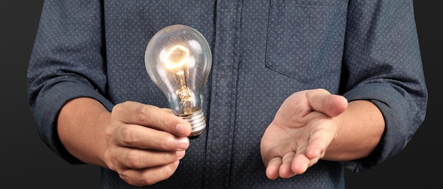 Humans hold light bulbs in hand innovative technology and creativity