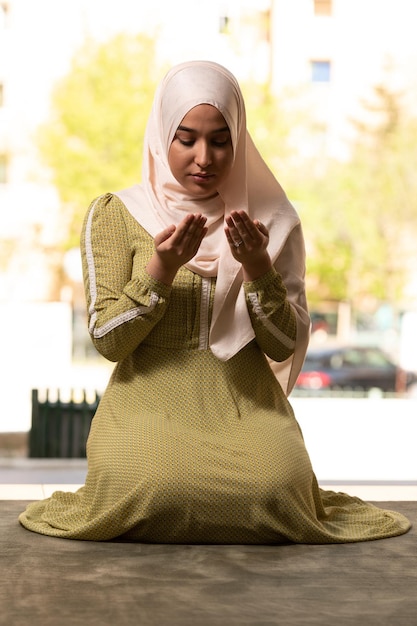 Humble Muslim Woman is Praying in the Mosque