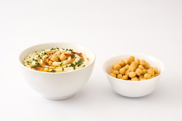 Hummus in bowl isolated on white table