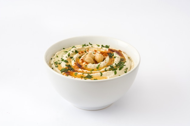 Hummus in bowl isolated on white table