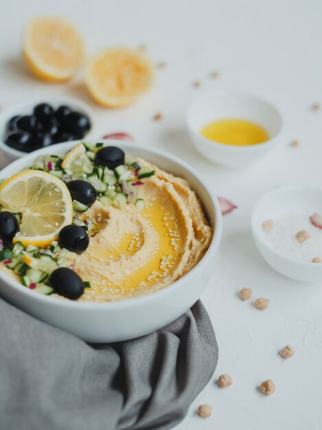 Hummus from chickpeas, with olive oil, olives, lemon, garlic