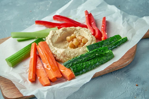 Hummus met groentesticks van peper, komkommer, wortel en selderij