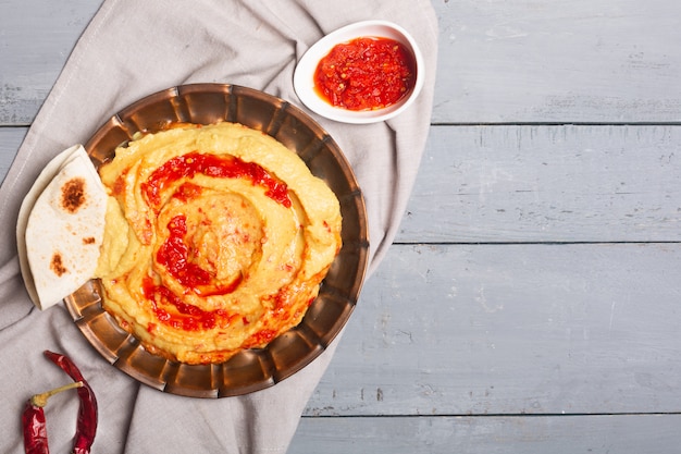 Hummus on a plate. Chickpea dish prepared with harissa sauce