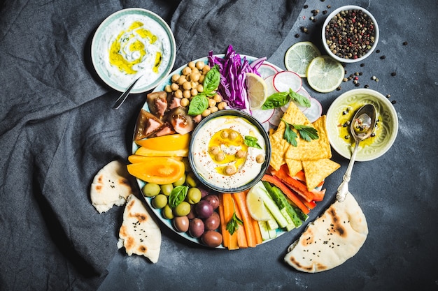 Hummus platter with assorted snacks