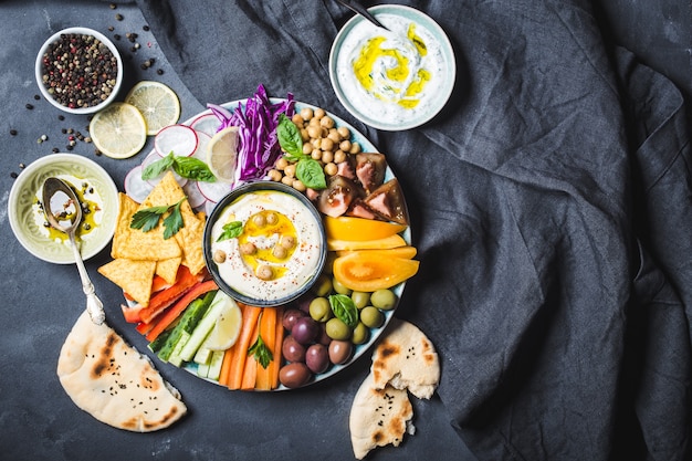 Hummus platter with assorted snacks