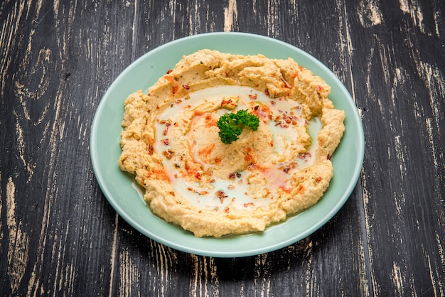 Hummus traditional Jewish creamy lunch salad with chickpeas, olive oil and paprika.