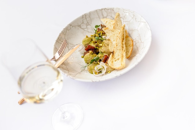 Hummus with croutons on a white background