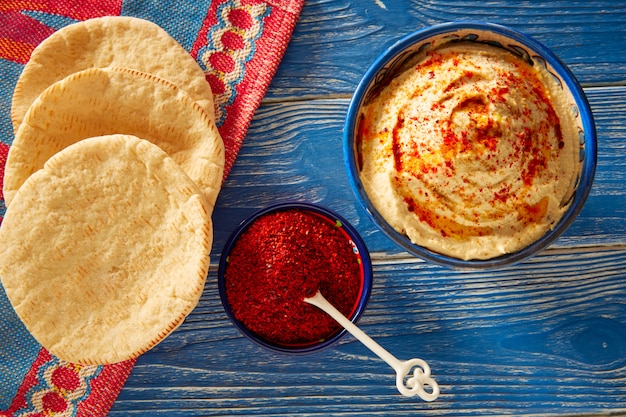 Hummus with pita bread and red pepper powder