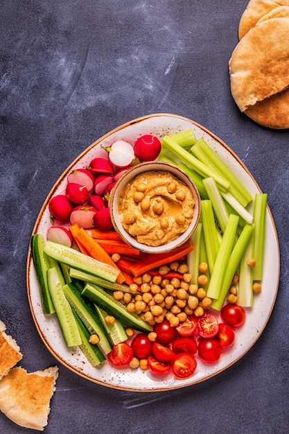 Hummus with various fresh raw vegetables.