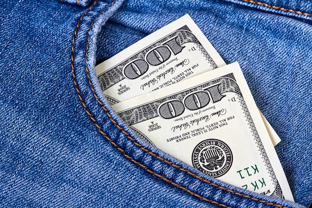 Hundred dollar bills in jeans pocket