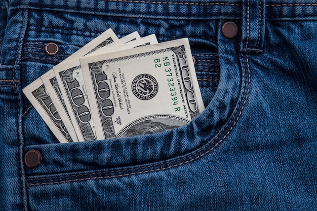 Hundred-dollar bills stick out of your jeans pocket.