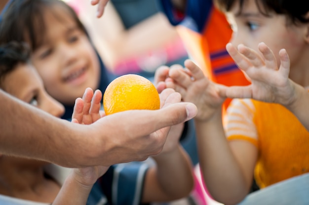 Hungry children being fed by charity