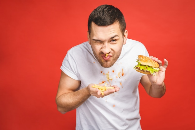 Hungry man eating junk food